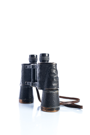 Old vintage binoculars on white background, shadows and reflections, Soviet binoculars of the Great Patriotic Warの写真素材