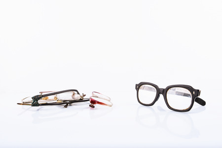 Old broken eyeglasses on white background, copyspace. Concept - update your old accessoryの写真素材