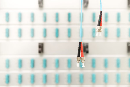 Fiber optic connectors with patch-panel on the background, server room, copyspace