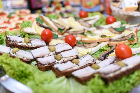 Lard on black brad, snack on a banquet table in a restaurantの写真素材