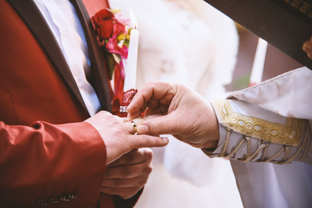 Priest put wedding ring on grooms finger, marriage vow, Christian traditions