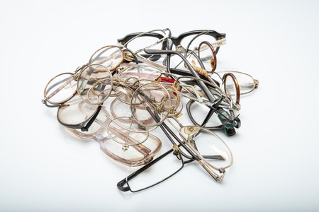 Vintage broken eyeglasses on white background. Concept - replace your old glassesの写真素材