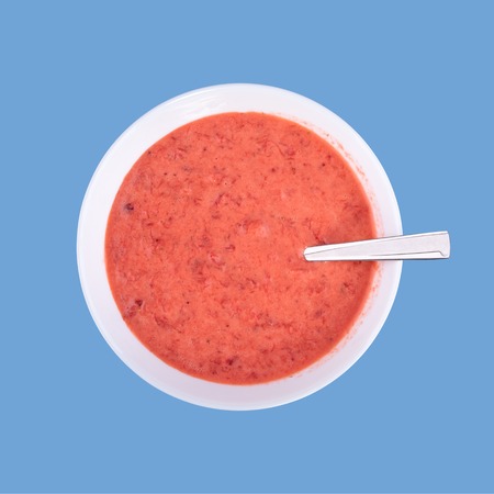 Fresh homemade yogurt, strawberries and sour cream mixed by using blender, isolated, top view, little boy blue color background with copy space for textの写真素材
