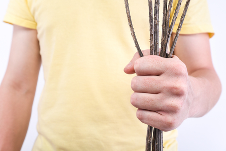 Man with a dry and prickly bouquet of teasels. Conception - breakup of relationshipsの写真素材