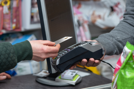 NFC technology, customer do payment with contactless credit card. Credit card reader implements payment execution, in the shopの写真素材