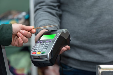 NFC technology, customer do payment with contactless credit card. Credit card reader implements...
