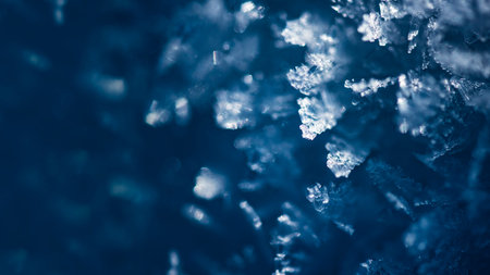 Crystals of snow cover, macro. Abstract winter background, banner 16x9 format