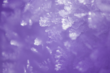 Abstract winter background with violet toning. Macro crystals of snow coverの写真素材