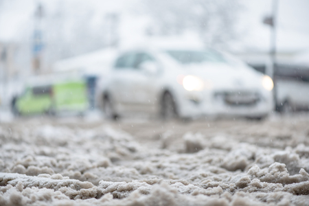 Snow slush on road, thaw, warming. Soft background with copy space for text.の写真素材