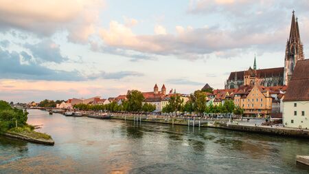 Regensburg, Germany - 26 July, 2018: Medieval architecture of Old Town of Regensburg city. Tourist ships on the Danube river. Regensburg Cathedral in the background. Popular tourist placesのeditorial素材