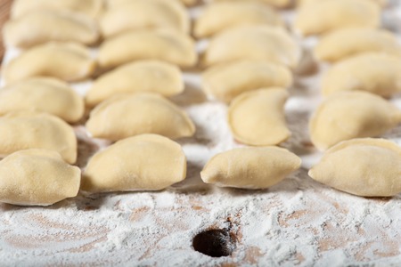 Raw dumplings ready to boil, close up. Also known as Vareniks, Ukrainian traditional cuisine.の写真素材