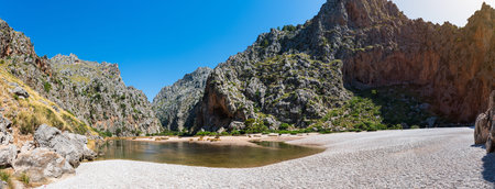 Beautiful summer panoramic landscape. River Torrent de Pareis between mountains. Wild beach in Sa Calobra, Palma de Mallorca, Spain. Popular tourist destinations.の写真素材