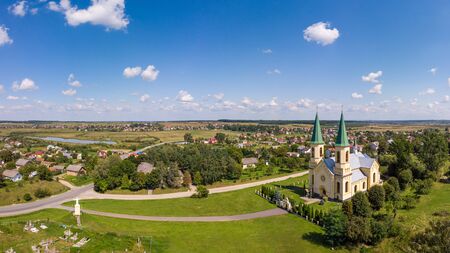 Summer landscape, countryside. Aerial drone view of old church and traditional Ukrainian villageの写真素材