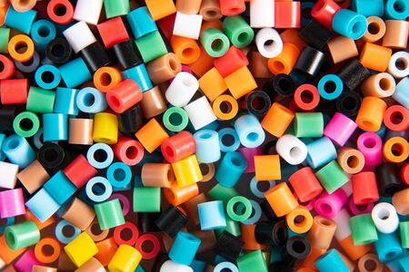 Set of multicolor fusible perler beads close up, top view. Kids toy that develops the imagination of child. Theme of leisure, hobby and development.の写真素材