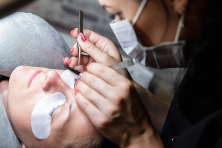 Eyelash stacking. Process of eyelash extensions in the beauty studio. Theme of beauty and care for...