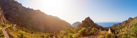 Super wide-angle scenic panoramic landscape of nature in Mallorca island. Hairpin turn between rocky mountains. Winding road to Sa Calobra picturesque port village, Escorca, Majorca, Balearic Islandsの写真素材