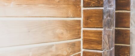 Wall of log house or log building close up. Theme of healthy housing, services of house construction from wooden logs, varnishing or putting. Wide-angle natural background with copyspaceの写真素材