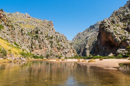 Mountain river stretches between high cliffs. Picturesque landscape of wild nature. Summer time it is time for travel and visits an exotic destinations.の写真素材