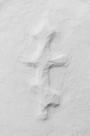 Russian Orthodox cross created on the surface and whitewashed with lime, close upの写真素材