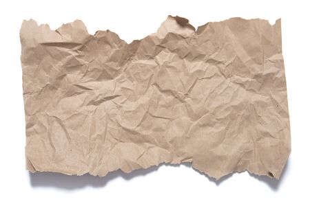 Fragment brown paper with torn edges and crumple traces. Object on white background with shadow.の写真素材