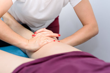 Process of body massage closeup. Caucasian woman in massage salon. Body treatment and care