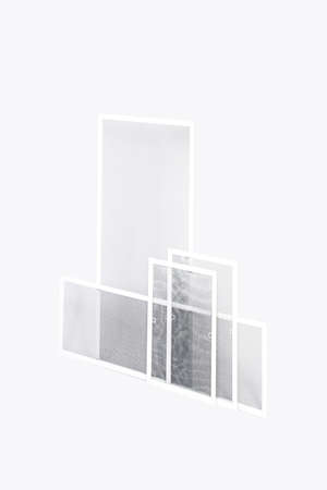 Window mosquito nets of different sizes, angle view. Reliable protection against mosquitoes, flies, and insects.の写真素材
