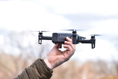 10 April 2022 - Krakow, Poland: man launches Drone Parrot ANAFI Thermal flying into the air.のeditorial素材