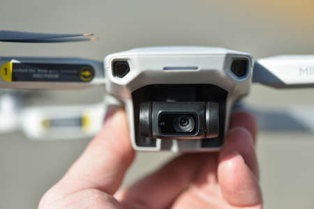 10 April 2022 - Krakow, Poland: New Drone DJI Mavic Mini 2 ready to fly. Pilot holds drone, close-up view.のeditorial素材