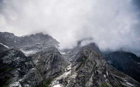 Mountains of Norway in fog and cloudsの写真素材
