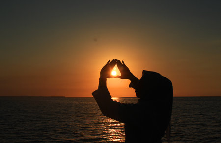 Sunset on a beautiful beach. A girl enjoying it.の写真素材