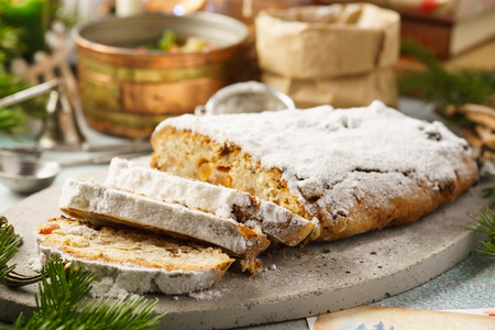 Traditional German stollen, sweet cake with candied fruit and raisins. Christmas sweet gift idea. Selective focus.の写真素材
