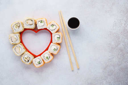 Heart shaped set of sushi rolls for Valentine's Day. Menu or delivery concept with space for text. Top view.の写真素材
