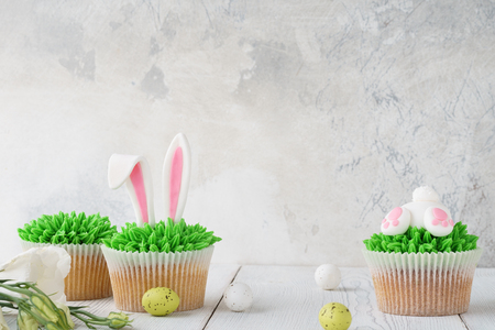 Easter bunny butt and ears cupcakes. Recipe or menu mockup with copy spaceの写真素材