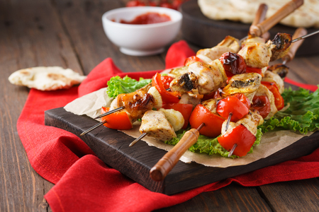 Chicken kebab on skewers with mushrooms, bell peppers and barbecue tomato sauce.の写真素材