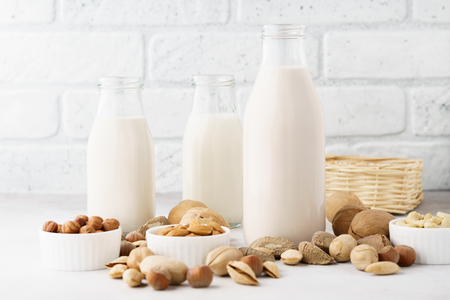 Various nut milk in bottles and ingredients. Dairy free, no lactose vegan milk concept.の写真素材