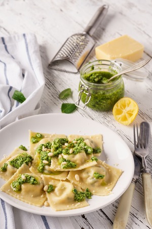 Italian spinach ravioli with pesto sauce, parmesan and cedar nuts.の写真素材