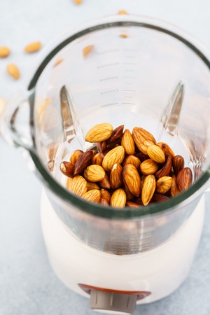 Blender with soaked almonds for making nut milk. Dairy free, no lactose vegan milk. Step by step recipe.の写真素材