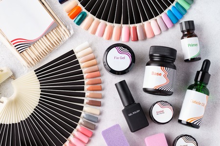 Set of cosmetic tools and accessories for manicure and pedicure - gel polishes, swatch palettes, nail files. Flat lay.の写真素材