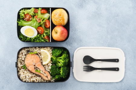 Lunch boxes with food ready to go for work or school. Meal preparation or dieting concept. Space for text.の写真素材