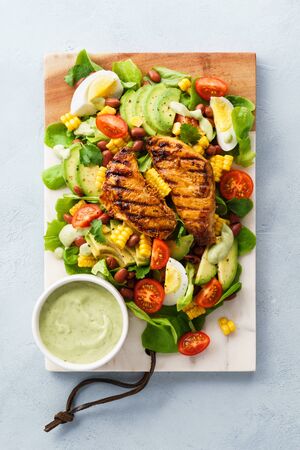 BBQ chicken cobb salad with avocado ranch dressing. Healthy food.の写真素材