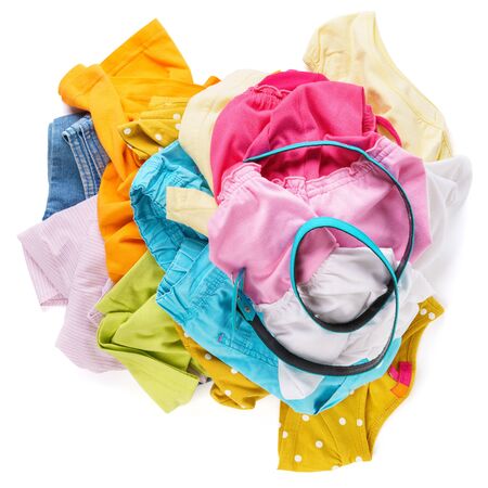 Messy pile of colorful summer clothes isolated on white background.の写真素材