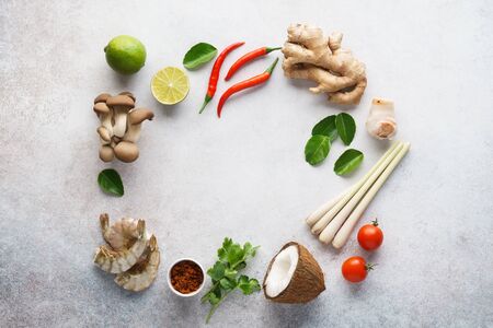 Frame made of various ingredients for making Tom Yum - traditional spicy Thai soup with mushrooms, prawns or shrimps and coconut milk. Background with copy space.の写真素材
