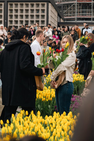 Berlin, Germany - 14 March 2026: Visitors hold freshly picked tulips during a public flower event in...
