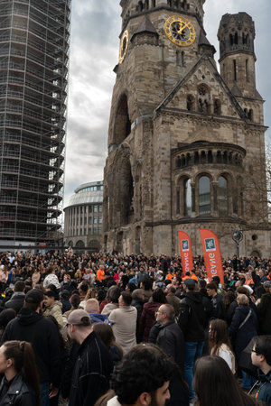 Berlin, Germany - 14 March 2026: A large crowd gathers near Kaiser Wilhelm Memorial Church at...