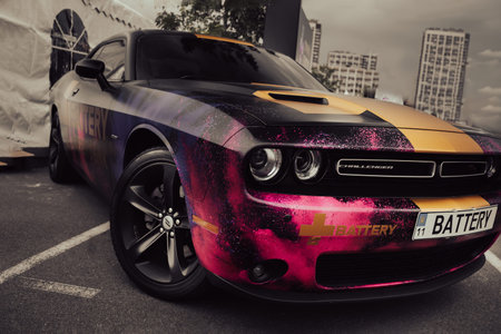 KYIV, UKRAINE - JUNE 8, 2024: Front wheel and headlight of the customized Dodge Challenge with a...