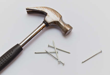 Hammer and construction nails on isolated white background, close-up.の写真素材