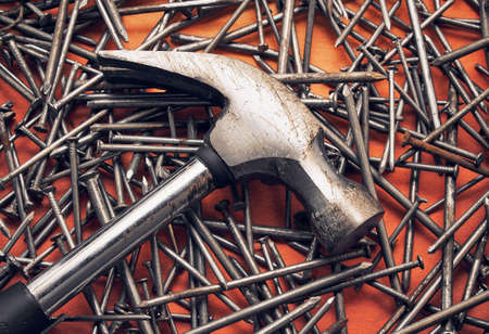 Hammer and a bunch of construction nails closeup. Repair concept.の写真素材