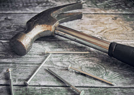 Hammer and a bunch of construction nails closeup. Repair concept.の写真素材