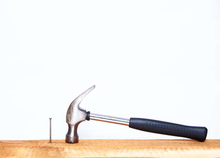 Hammer and construction nails on isolated white background close-up. With place under the text.の写真素材