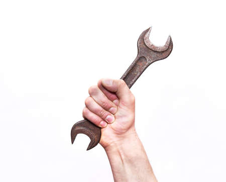 Wrench in hand on a white isolated background. Close up. The concept of repair.の写真素材